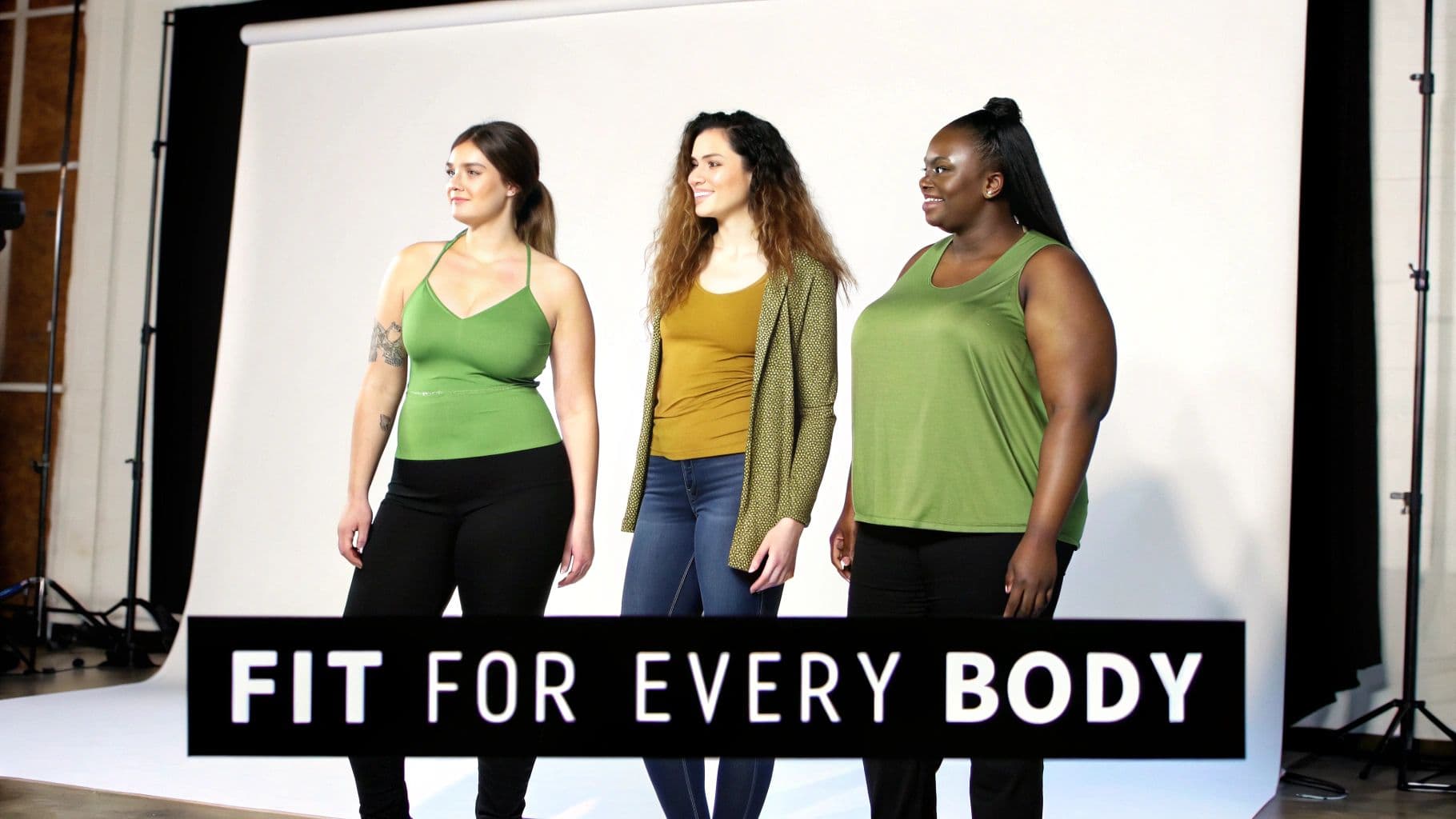 Three diverse women with different body types pose in green tops during a clothing photoshoot.