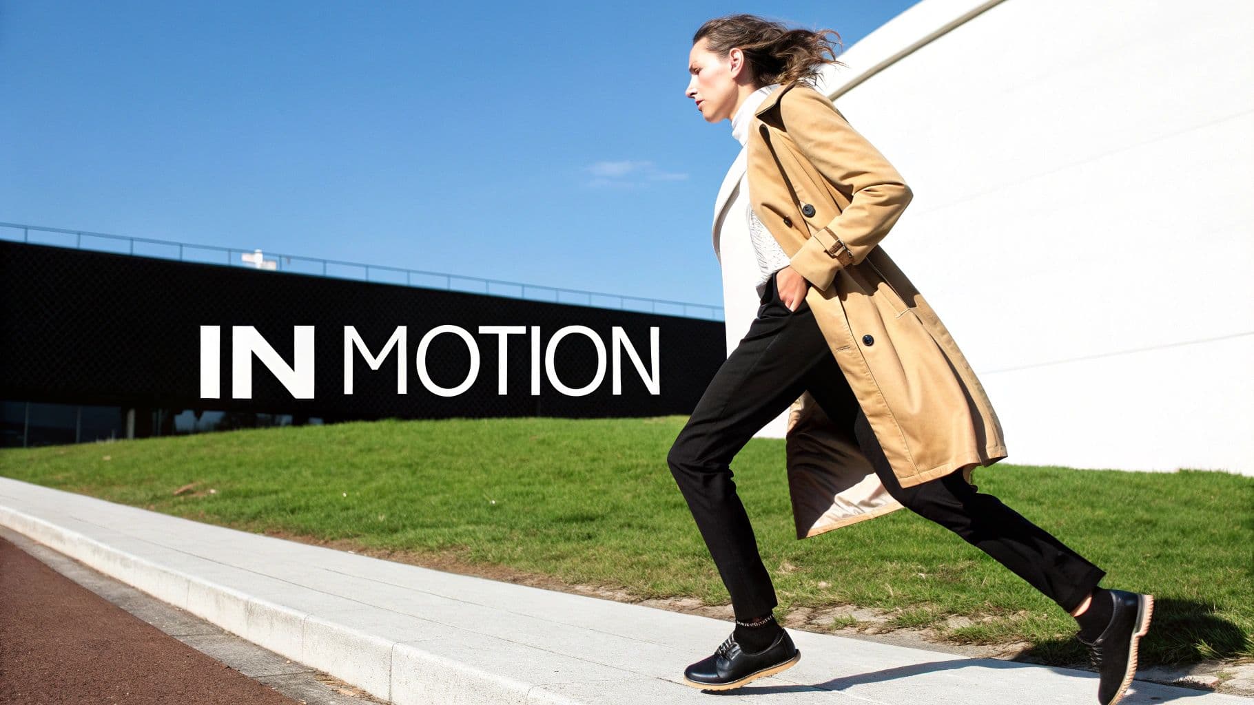A fashion model in a beige trench coat and black pants running on a sidewalk with "IN MOTION" text.