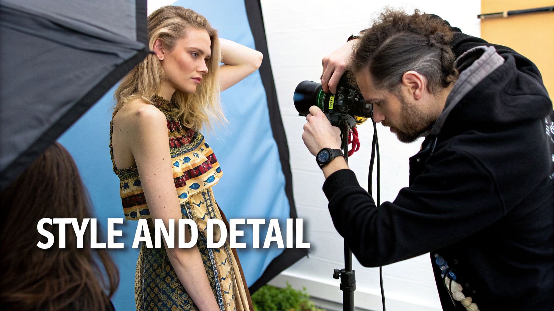 A photographer captures a stylish blonde model wearing a detailed, colorful dress during a photoshoot.